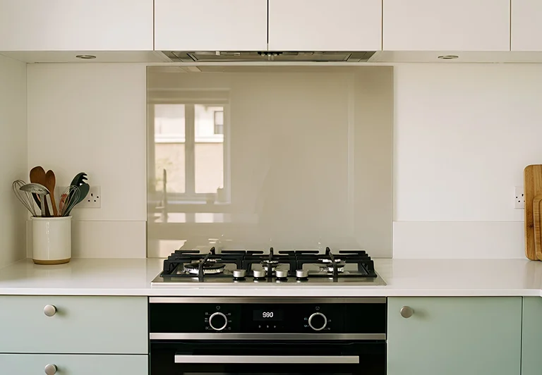 Glass splashback in duck egg coloured kitchen